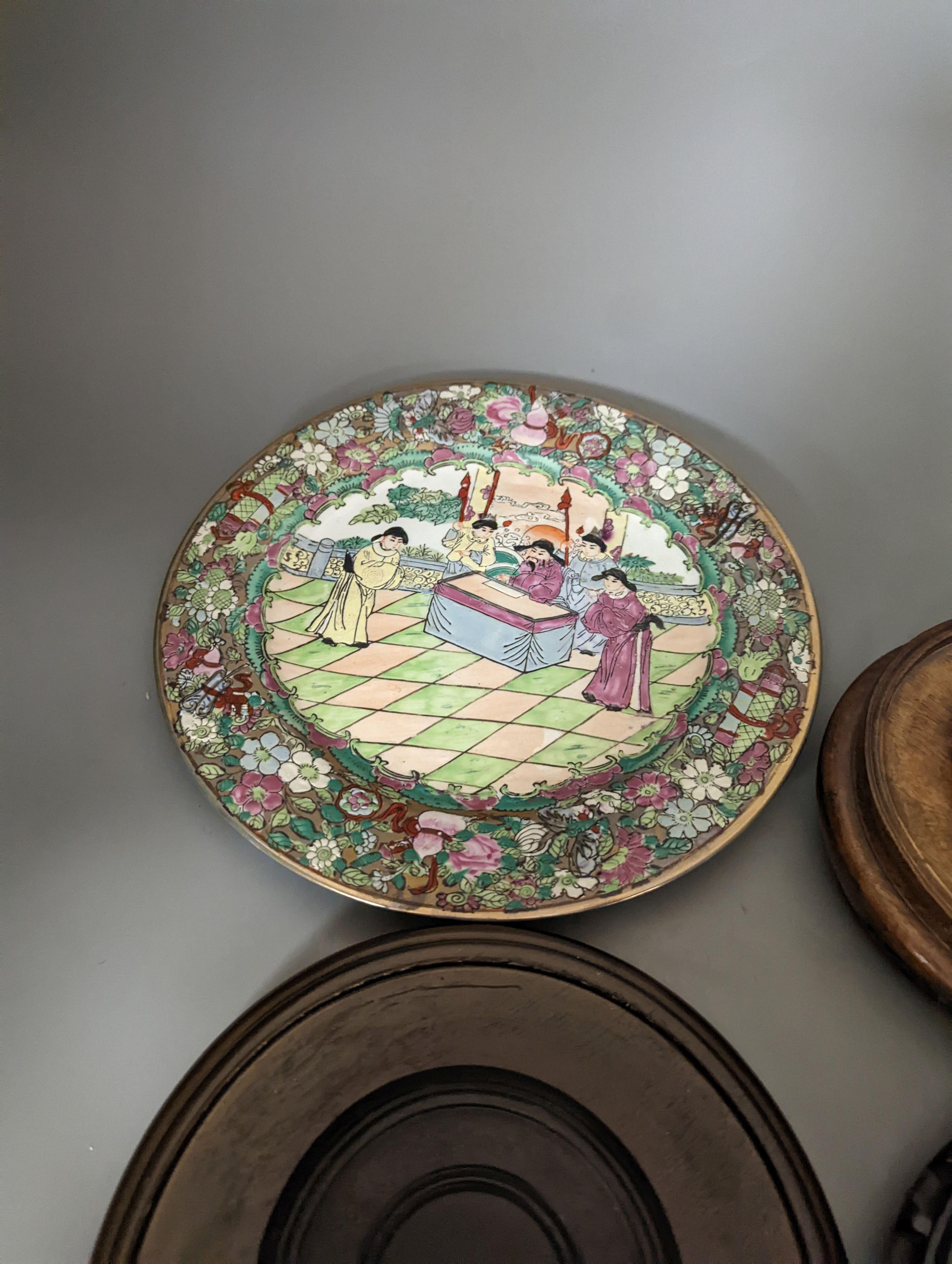 A Chinese famille rose bowl, plate and four stands, bowl 31 cms diameter.